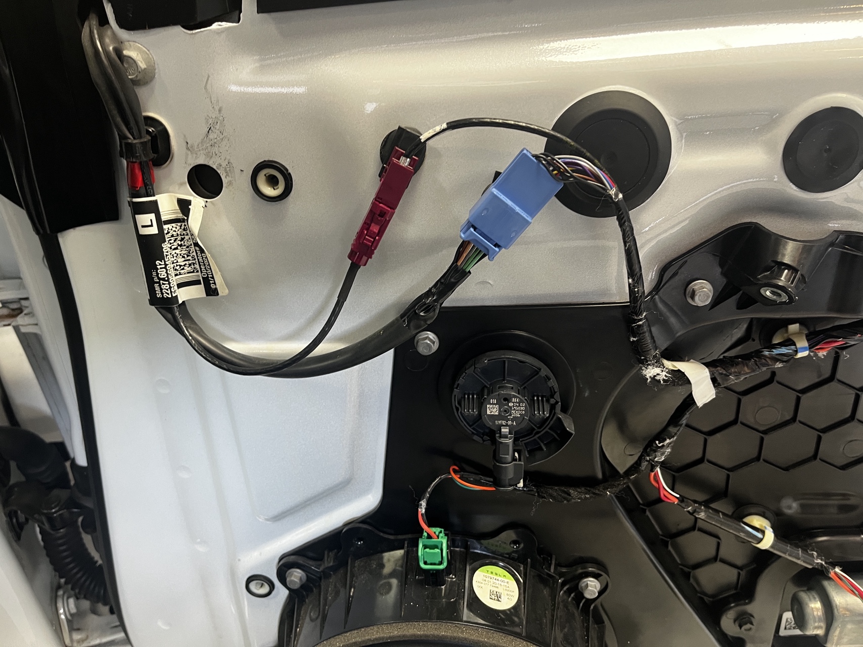 Tesla Model 3 door panel removed showing antenna wiring routes