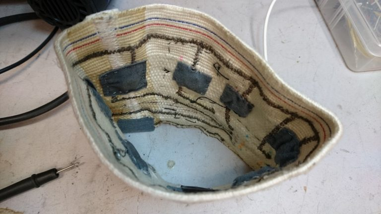 Inside of the haptic compass band showing vibration motors and conductive thread traces