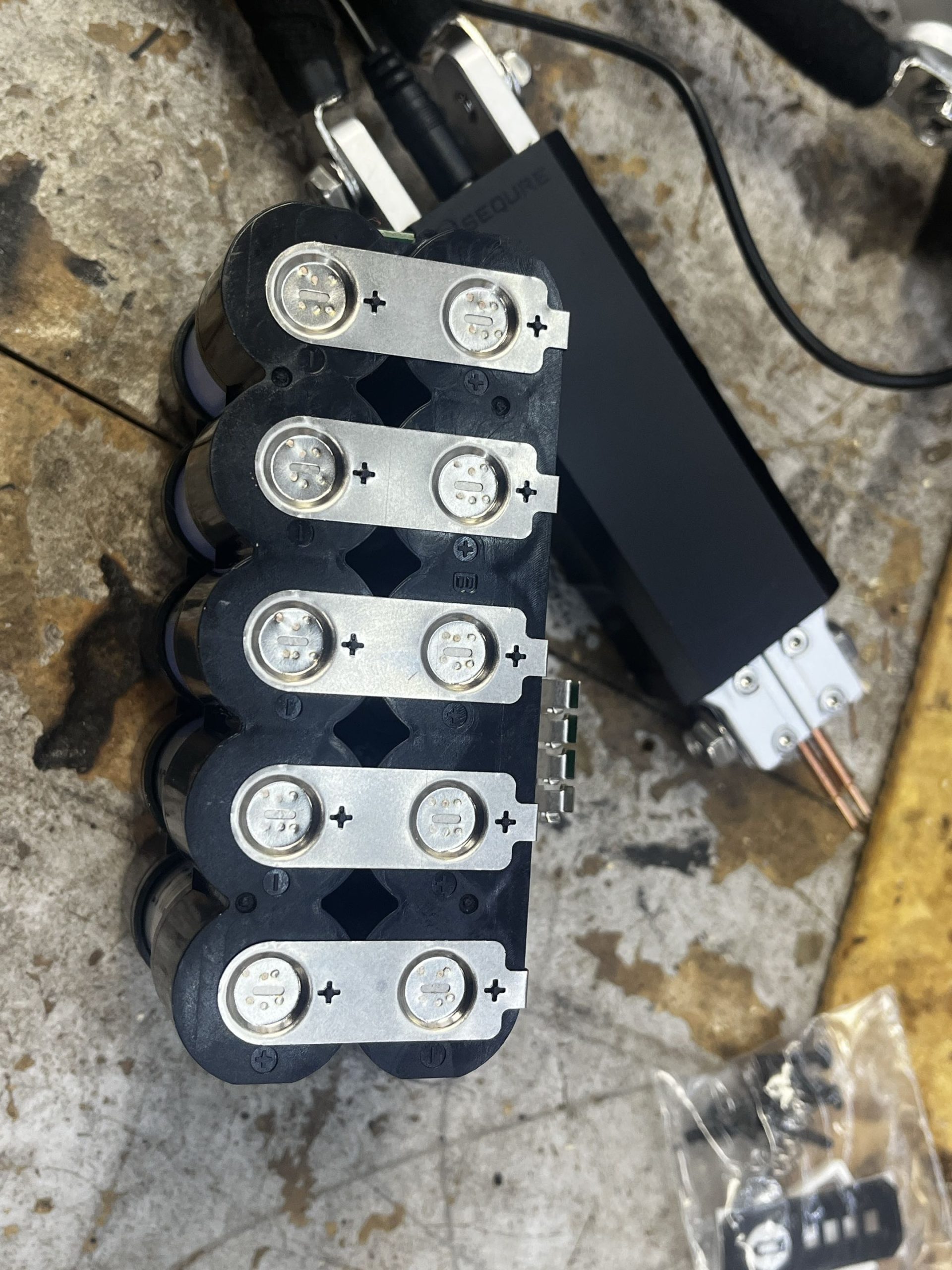 21700 lithium cells in plastic spacer with nickel strips spot welded