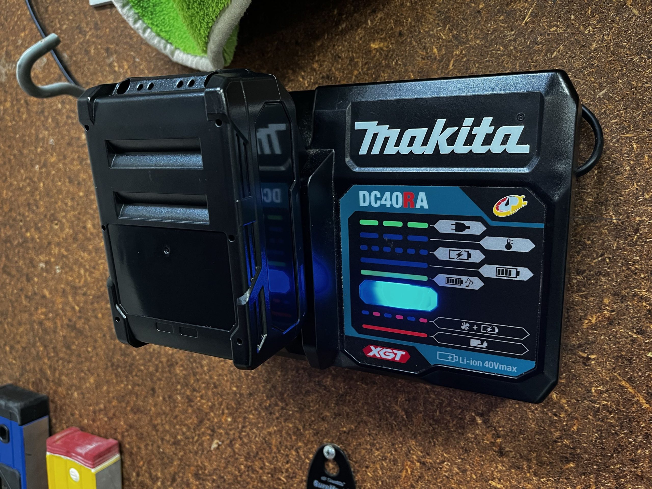 DIY Makita 40V battery on DC40RA charger with blue LED indicating successful charging