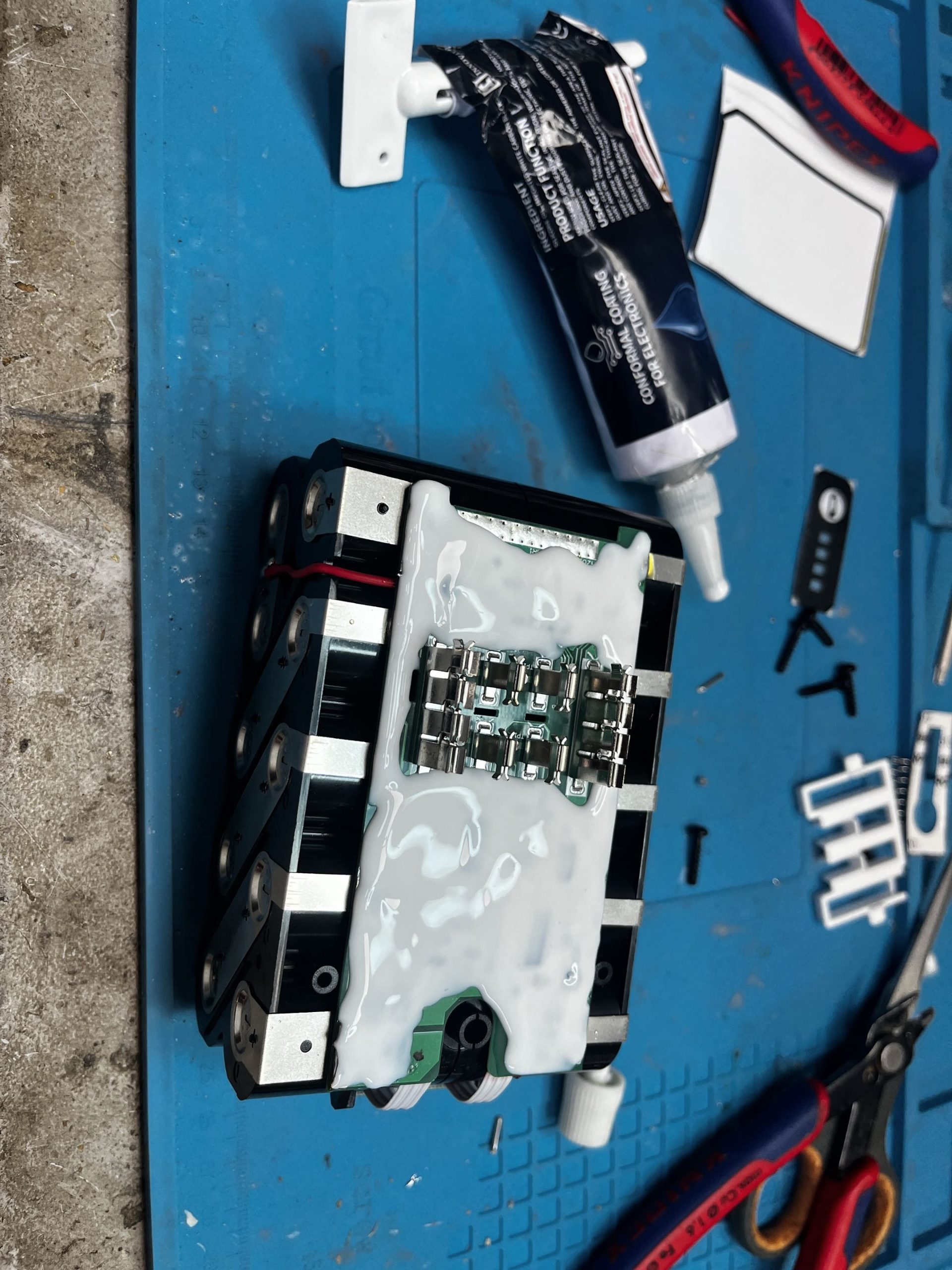 Potting compound applied over BMS board for dust and vibration protection